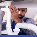 EJ Plumber fixing under the sink