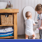 two young kids looking into a toilet