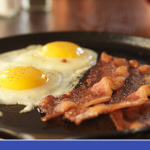 skillet with fried eggs and bacon