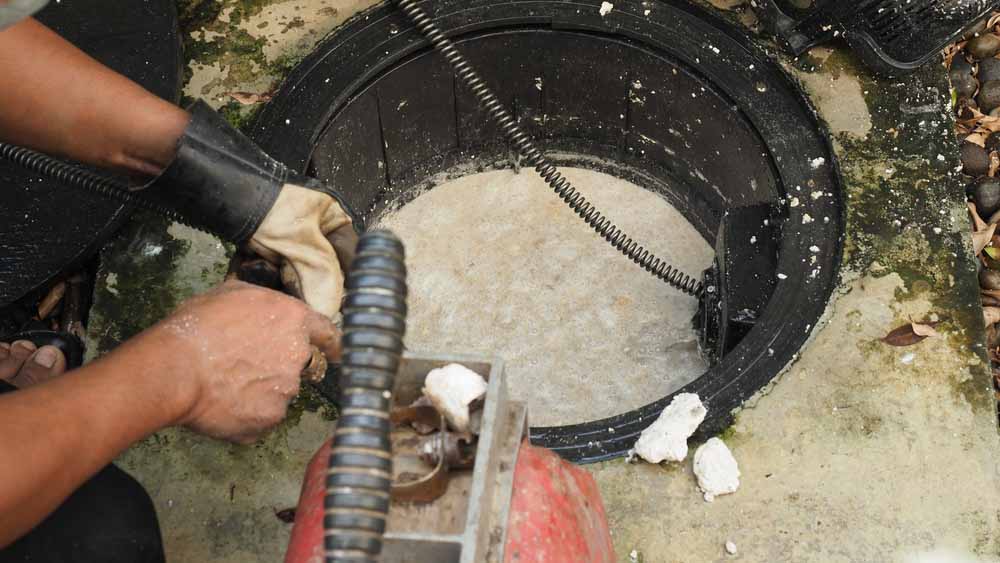 Plumber repairing clogged grease trap Los Altos Hills, CA