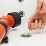 Auger being inserted into a clogged drain