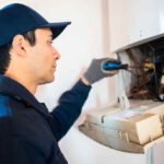 technician repairing a water heater