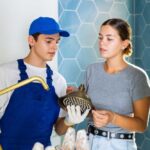 plumber from EJ Home Services talking to homeowner