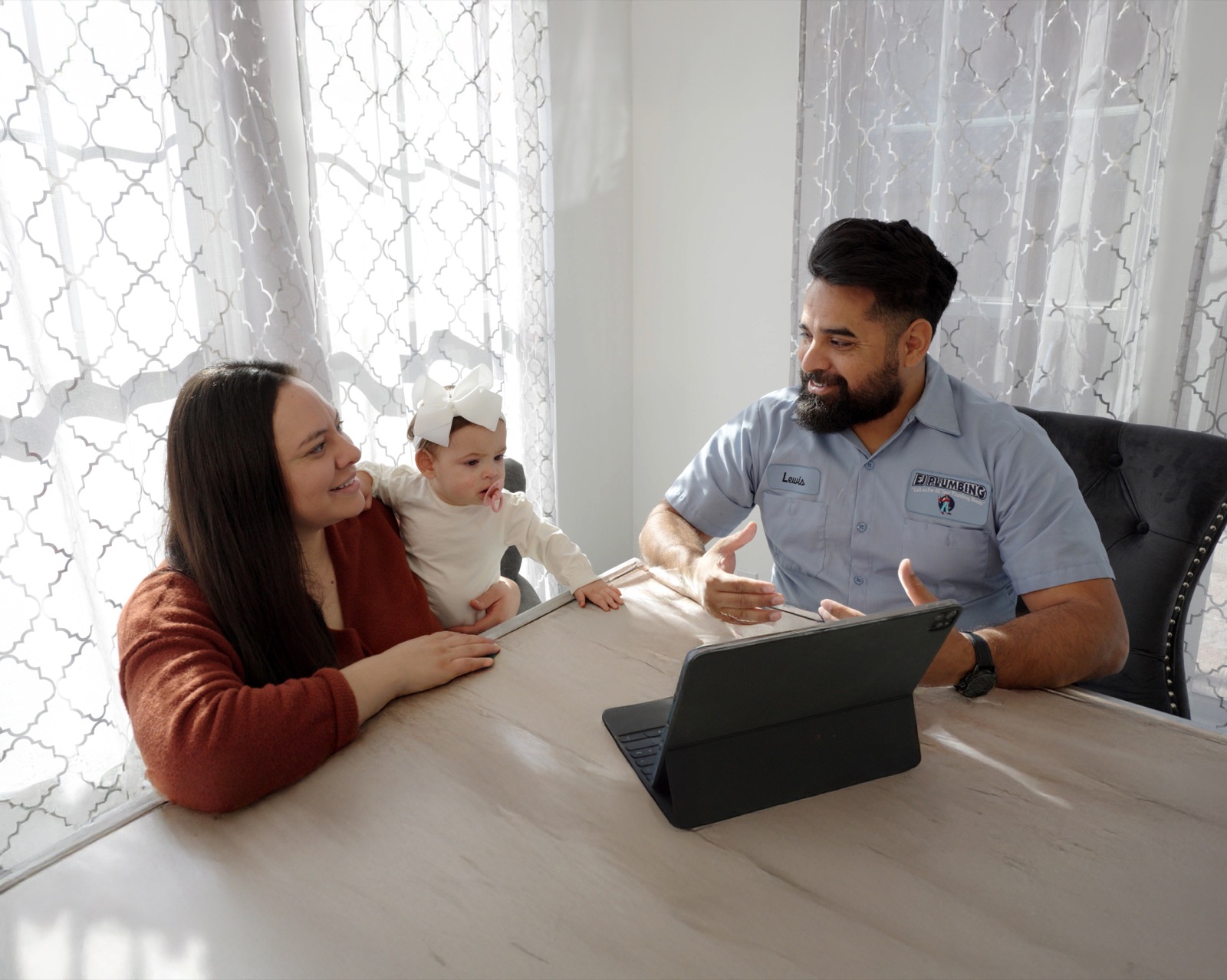 EJ technician reviewing service options with a homeowner