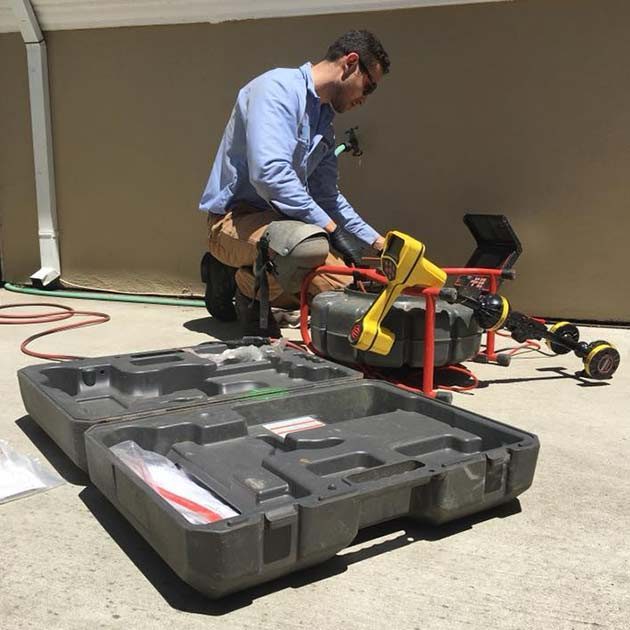 Plumber Using Camera Inspection Equipment Plumber Using Camera Inspection Equipment